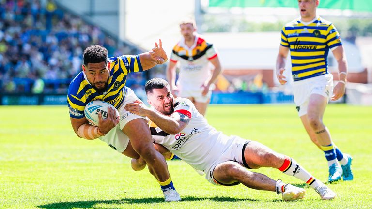 Kelepi Tanginoa is tackled by Caleb Aekins 