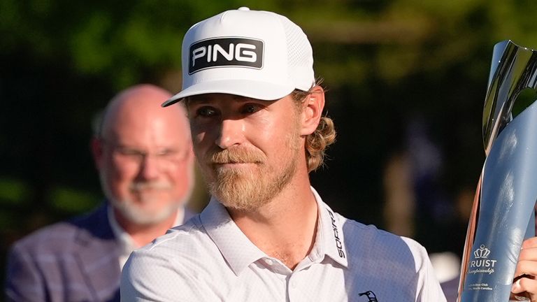 Kristoffer Reitanholds the trophy after winning the Truist Championship golf tournament at the Quail Hollow Club