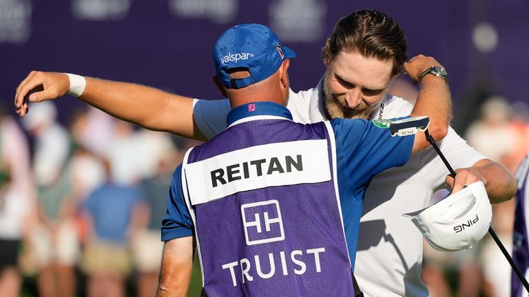 Kristoffer Reitan, of Norway, hugs his caddie after winning the Truist Championship golf tournament at the Quail Hollow Club