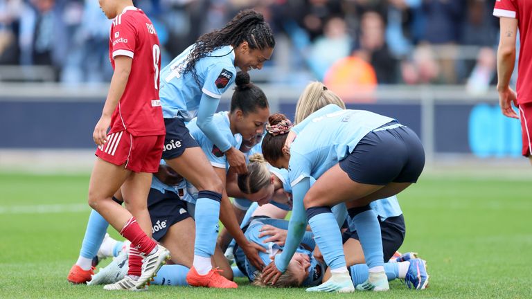 Rebecca Knaak is mobbed by team-mates after scoring last-gasp winner in victory over Liverpool