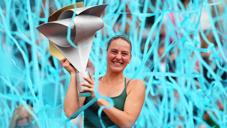 Marta Kostyuk of Ukraine celebrates with the trophy after winning the final match at the Madrid Open tennis tournament in Madrid, Spain, Sat