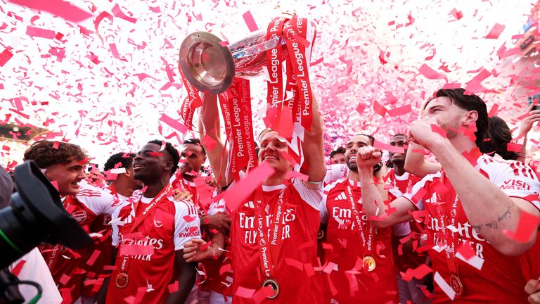 Martin Odegaard lifts the Premier Leaguer trophy