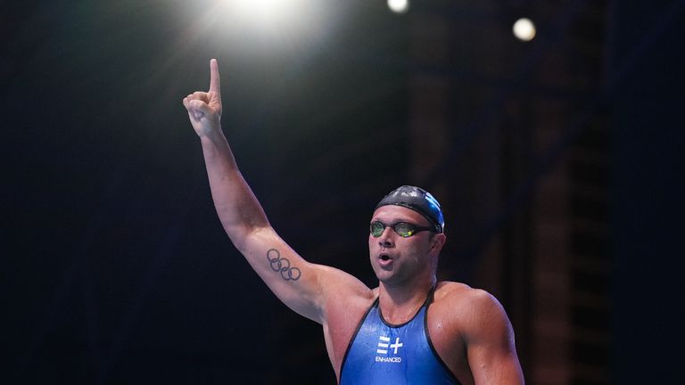 Cody Miller, of the United States, celebrates after winning the men's 100-meter breaststroke final
