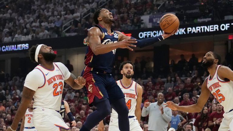 Cleveland Cavaliers guard Donovan Mitchell (45) shoots against New York Knicks center Mitchell Robinson (23).