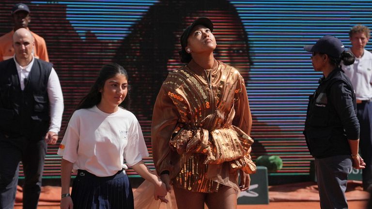 Naomi Osaka of Japan enters the court for the third round women's singles tennis match against Iva Jovic of the U.S. at the French Open tennis tournament in Paris, Saturday, May 30, 2026. (AP Photo/Thibault Camus)