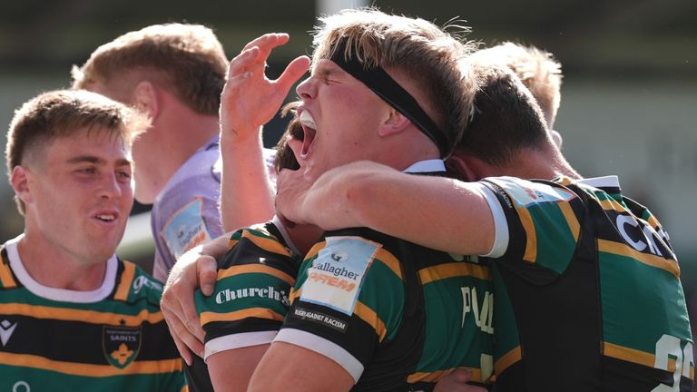 Northampton Saints star Henry Pollock envelops George Furbank after his winning score