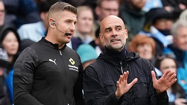 Manchester City manager Pep Guardiola (right) speaks to fourth official Robert Jones