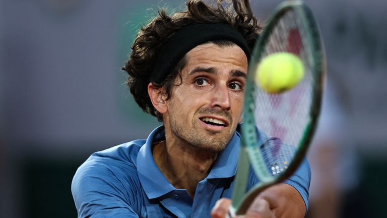 France's Pierre-Hugues Herbert returns with a backhand to Italy's Lorenzo Sonego during the men's singles match on day 1 of the French Ope.