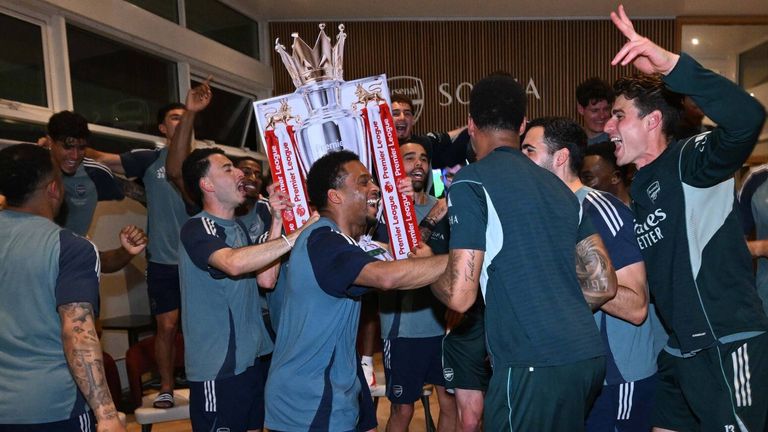 Arsenal players celebrate winning the Premier League after watching Bournemouth v Man City at their London Colney training centre