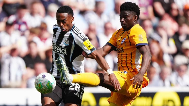 Joe Willock and Carlos Baleba battle for the ball