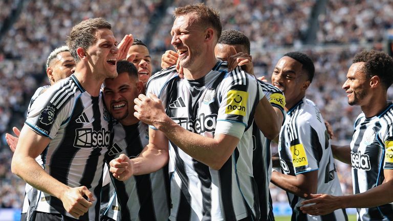 Dan Burn celebrates with his team-mates after scoring Newcastle's second goal against Brighton