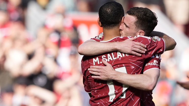 Mohamed Salah hugs Andy Robertson before leaving the field