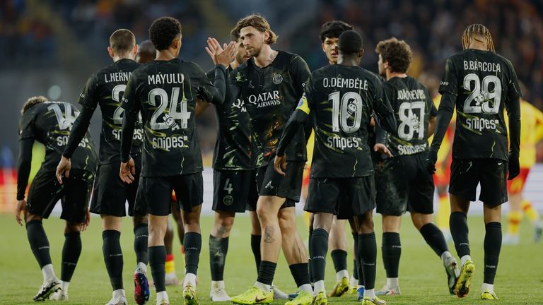 PSG's players celebrate after Khvicha Kvaratskhelia, unseen, scored the opening goal against Lens