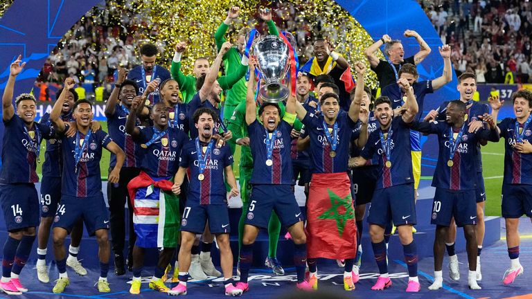 PSG's Marquinhos lifts the trophy after winning the Champions League (AP Photo/Petr Josek)