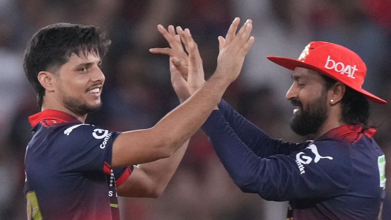 Royal Challengers Bengaluru's Rasikh Dar, left, celebrates the wicket of Gujarat Titans' Rahul Tewatia 