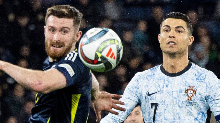GLASGOW, SCOTLAND - OCTOBER 15: Scotland's Anthony Ralston and Portugal...s Cristiano Ronaldo during a UEFA Nations League Group A1 match between Scotland and Portugal at Hampden Park, on October, 15, 2024, in Glasgow, Scotland. (Photo by Ross MacDonald / SNS Group)