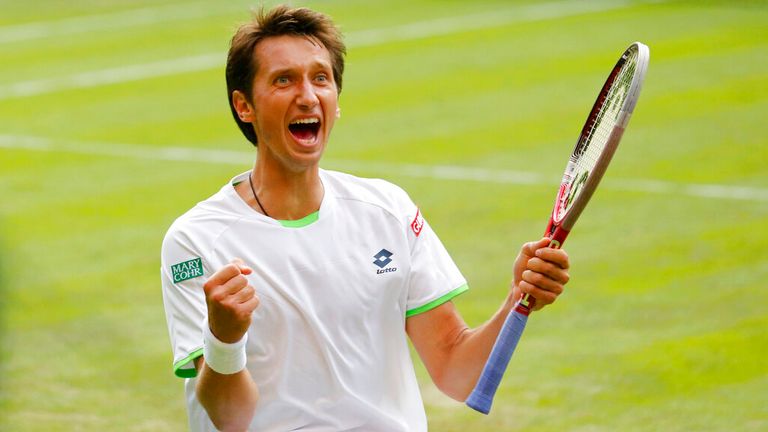 Sergiy Stakhovsky of Ukraine reacts as he wins against Roger Federer of Switzerland in their men's second round singles match at the All Eng