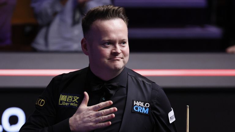 Shaun Murphy celebrates after winning his match against John Higgins (not pictured) on day fifteen of the Halo World Snooker Championship 20