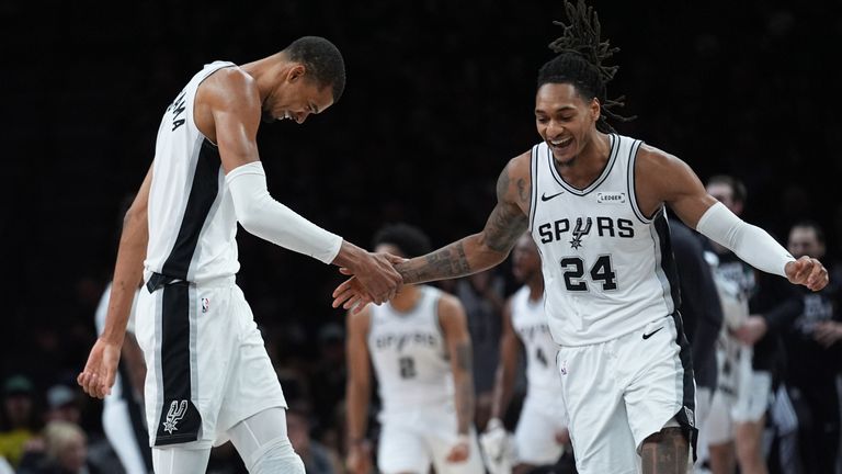 San Antonio Spurs guard Devin Vassell (24) and forward Victor Wembanyama (1) celebrate a score