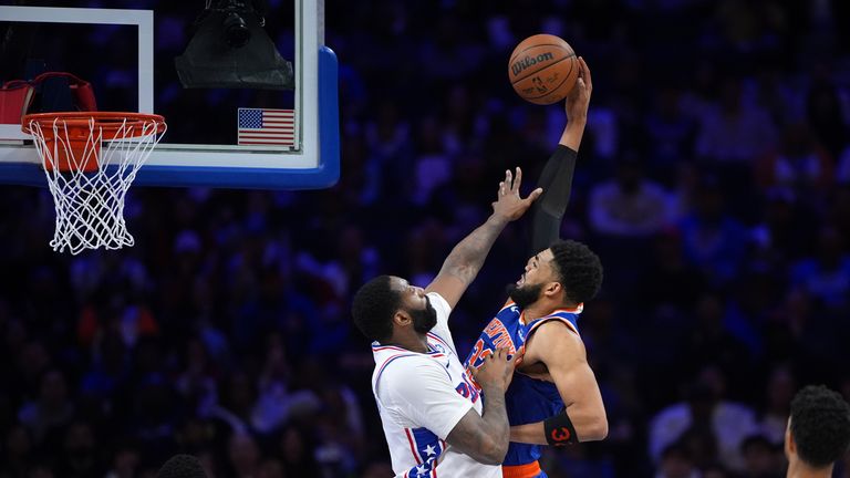 New York Knicks' Karl-Anthony Towns, right, goes up for a play against Philadelphia 76ers' Andre Drummond 