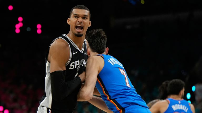 San Antonio Spurs forward Victor Wembanyama, left, reacts while defended by Oklahoma City Thunder center Chet Holmgren
