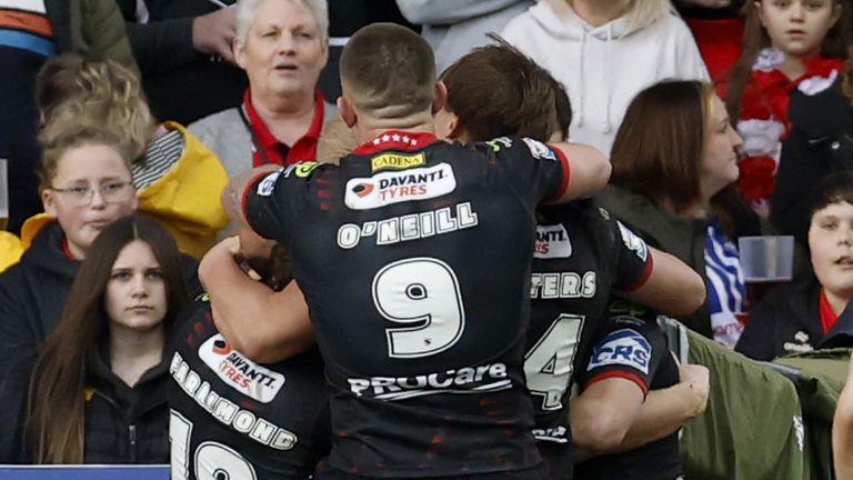 Wigan Warriors' Zach Eckersley (obscured) celebrates with his team mates after scoring a try 