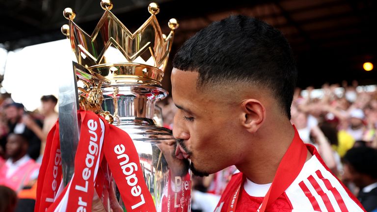William Saliba kisses the Premier League trophy having played a key role in their success