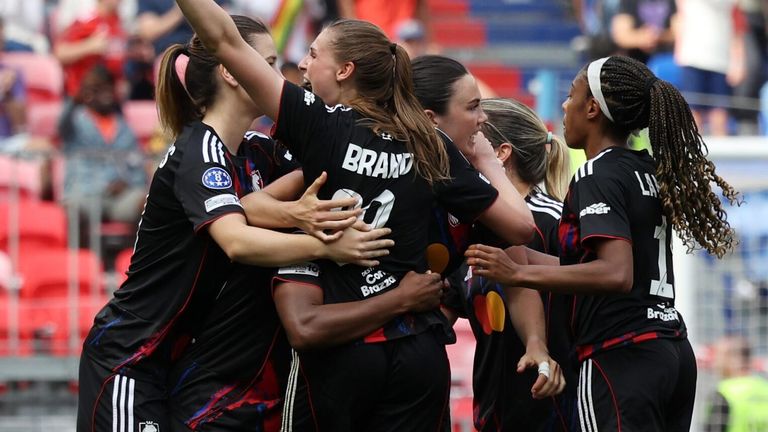 Jule Brand celebrates with her team-mates after scoring Lyon's third goal against Arsenal