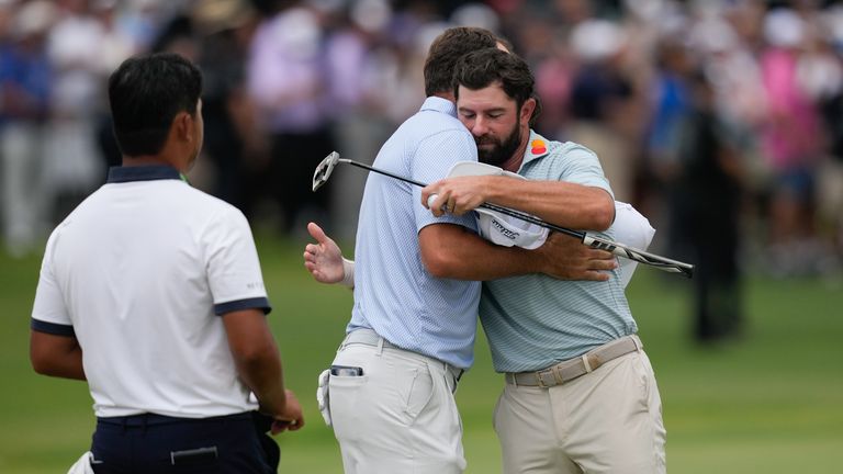 Cameron Young, right, greets Scottie Scheffler on the 18th hole after winning the Cadillac Championship 