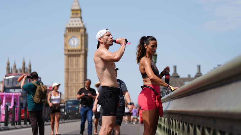 People on Westminster Bridge in London. The UK is set to bake in record-breaking temperatures amid rare red warnings over extreme temperatures that are expected to hit record highs for June. A "heat-dome" settling over western Europe could bring temp