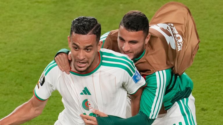 Algeria's Nadhir Benbouali, left, reacts with Yassine Titraoui after scoring his side's first goal during 