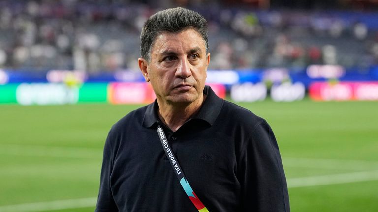 Iran head coach Amir Ghalenoei walks off the field after a draw during the World Cup Group G soccer match between Iran and New Zealand