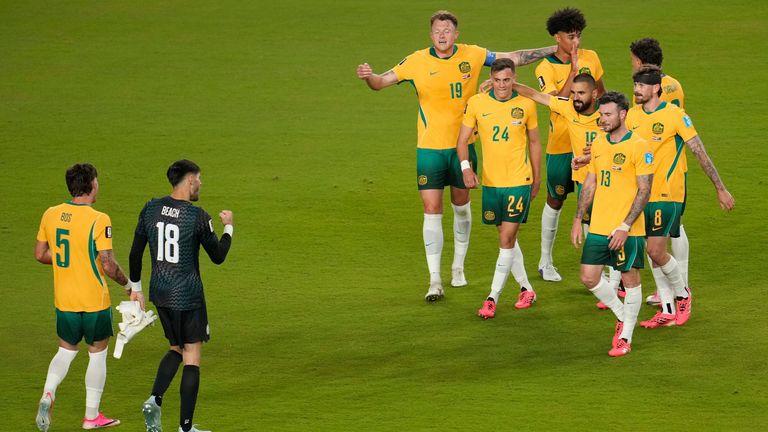Australia's players celebrate their progress to the last-32 of the World Cup