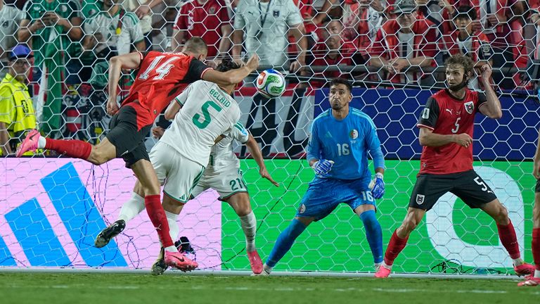 Austria's Sasa Kalajdzic heads in a 96th minute equaliser against Algeria