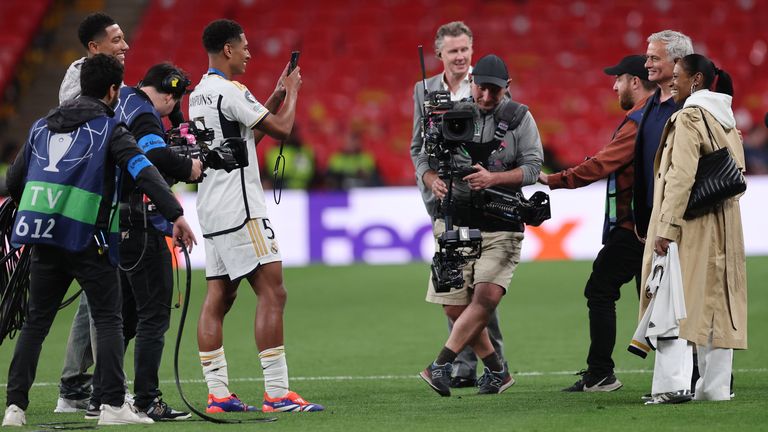 Jude Bellingham takes a photo of his mum with Jose Mourinho after the 2024 Champions League final