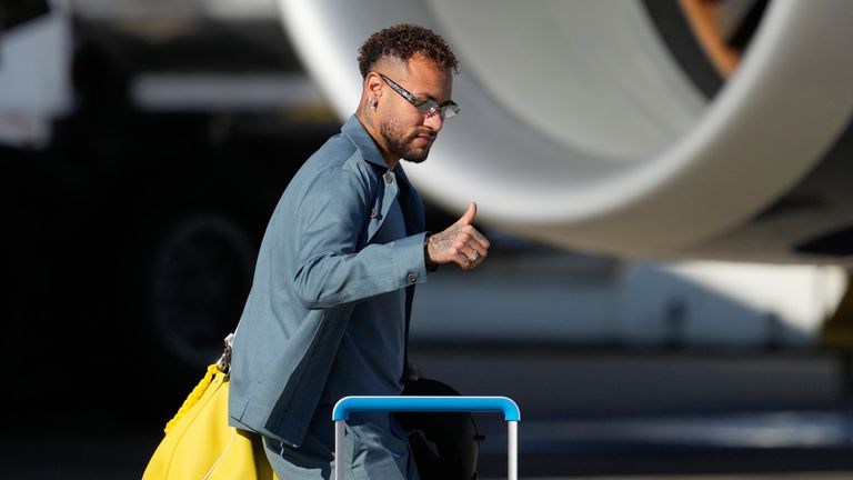Neymar gives a thumbs up as he disembarks at Newark Airport as the Brazil team arrives ahead of the World Cup
