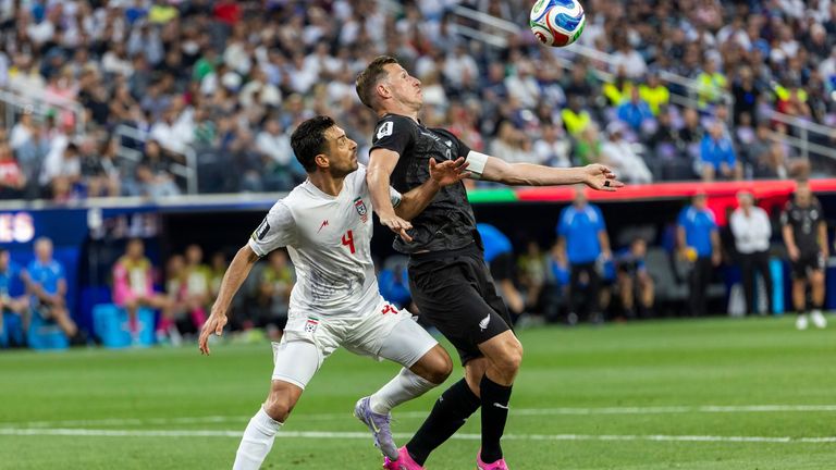 IR Iran' Shoja Khalilzadeh (4) and New Zealand' Chris Wood (9) vie for the ball during the FIFA World Cup Group G soccer match at SoFi Stadium in Inglewood, Calif., Monday, June 15, 2026. (Ringo Chiu via AP)