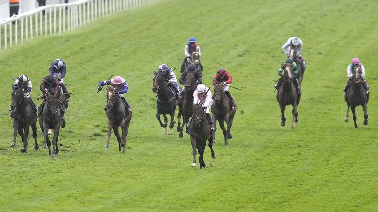 Christmas Day, ridden by Ronan Whelan (centre, pink silks), on the way to winning the Betfred Derby at Epsom