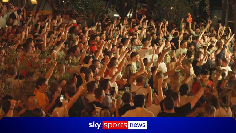 England fans celebrate in a fanpark