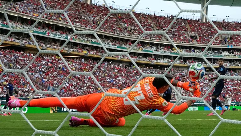 Uruguay goalkeeper Fernando Muslera is beaten by a shot from Spain's Alex Baena at the World Cup