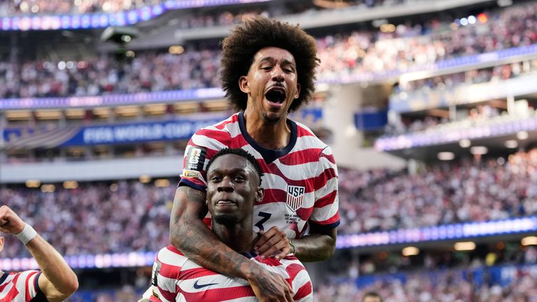 United States' Folarin Balogun (20) celebrates scoring his side's third goal against Paraguay with teamates during the World Cup Group D soccer match in Inglewood, Calif., near Los Angeles, Friday, June 12, 2026. (AP Photo/Andre Penner)