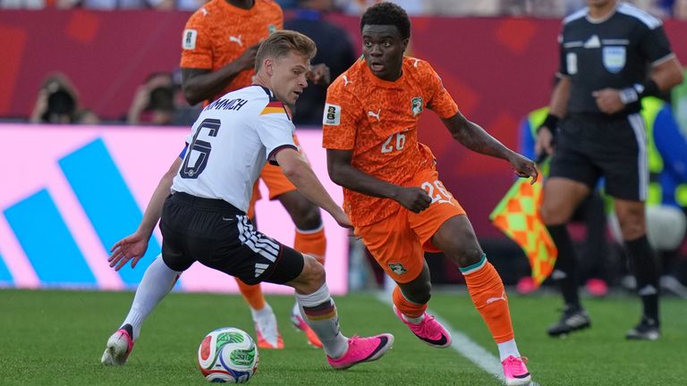 Germany's Joshua Kimmich, left, vies for the ball with Ivory Coast's Christ Inao Oulai