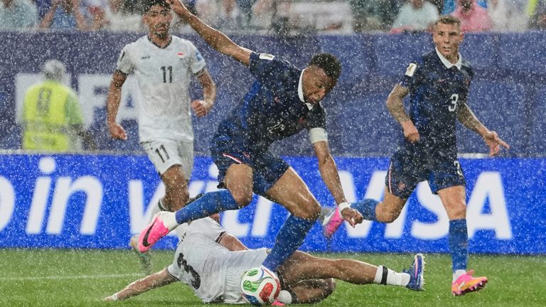 Iraq's Hussein Ali, bottom, challenges France's Kylian Mbappe during the World Cup Group I soccer match between France and Iraq in Philadelphia, Monday, June 22, 2026. (AP Photo/Matt Slocum)