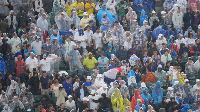 Fans wear ponchos to protect themselves from the rain during the World Cup Group I soccer match between France and Iraq in Philadelphia