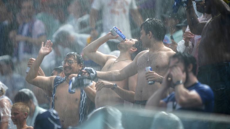 Fans react after a weather delay during the World Cup Group I soccer match between France and Iraq in Philadelphia