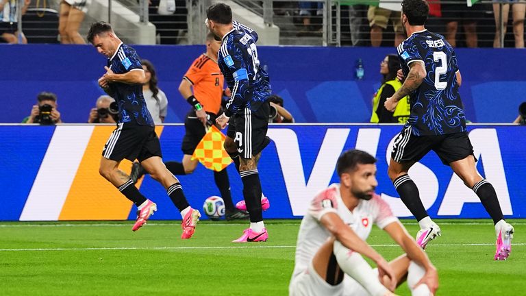Argentina's Giovani Lo Celso, left, celebrates after scoring his side's opening goal during the World Cup Group J match against Jordan