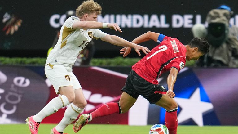 Heung-Min Son and Pavel Sulc battle for the ball during the World Cup match between South Korea and Czechia