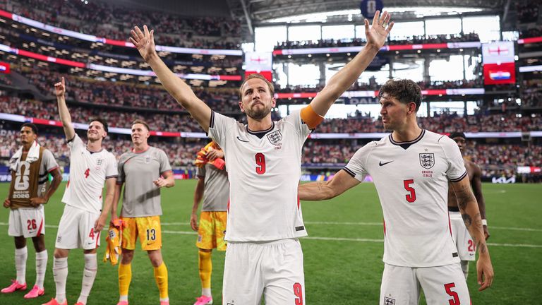 Harry Kane and the England players sing and celebrate with their supporters after beating Croatia