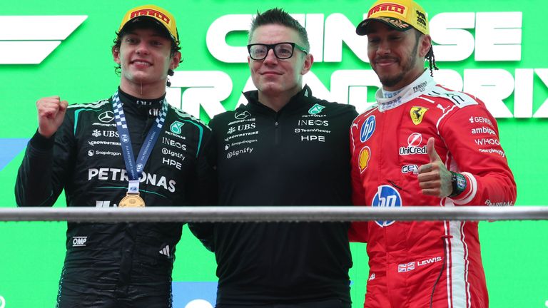 Kimi Antonelli, Peter Bonnington and Lewis Hamilton on the podium at March's Chinese Grand Prix