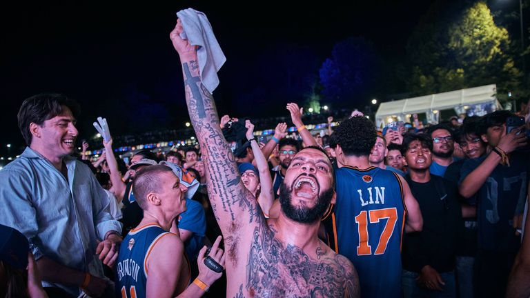 Knicks fans line the streets of NeW York as they celebrate  celebrate their victory 
